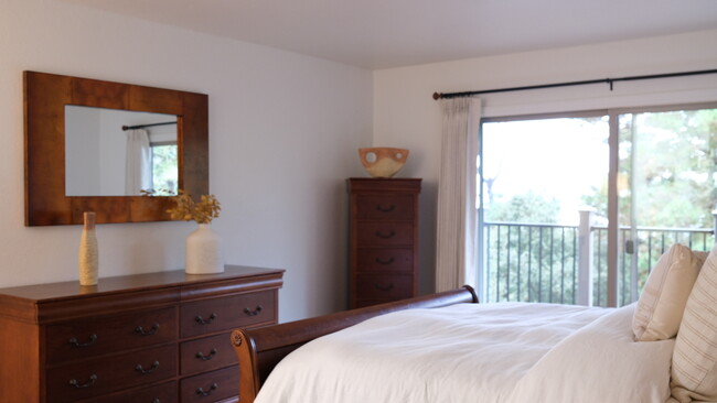 Primary bedroom with ocean view from bed - 250 Forest Ridge