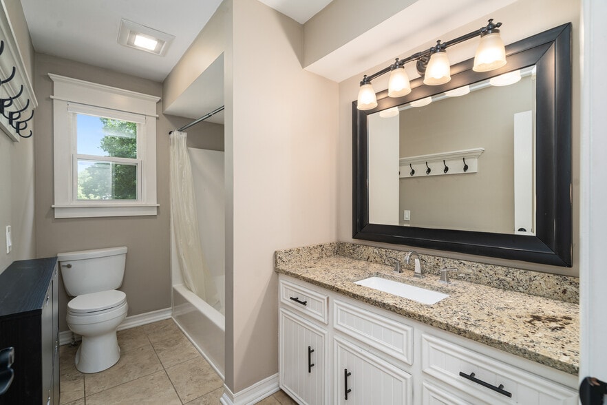 Bathroom with granite counters and custom trim - 223 E Division St