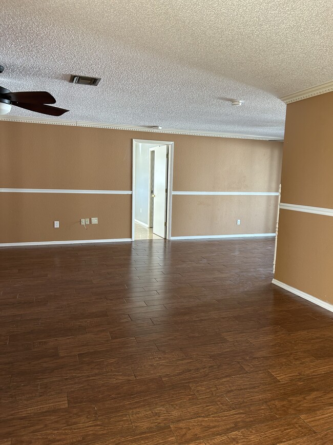 Living room and dining area at master bedroom entrance - 18200 Adams Cir