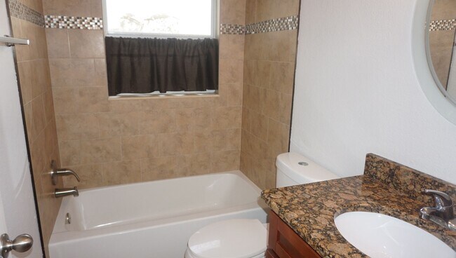 Building Photo - Four Bed - Three Bath - Large Storage Area...