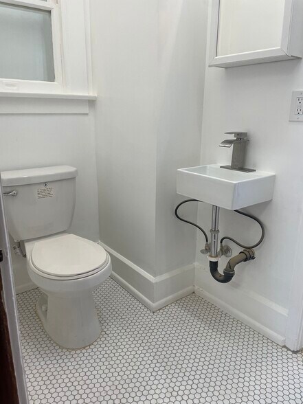 Completely renovated half bathroom that is the smallest of the three bathrooms. - 1135 Magnolia St