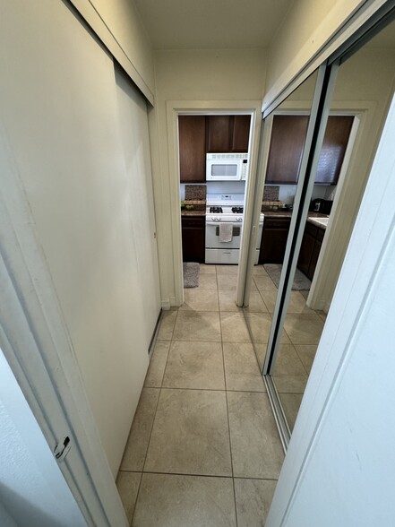 Two Double sliding door closets with shelving on both sides of hallway - 33966 Malaga Dr