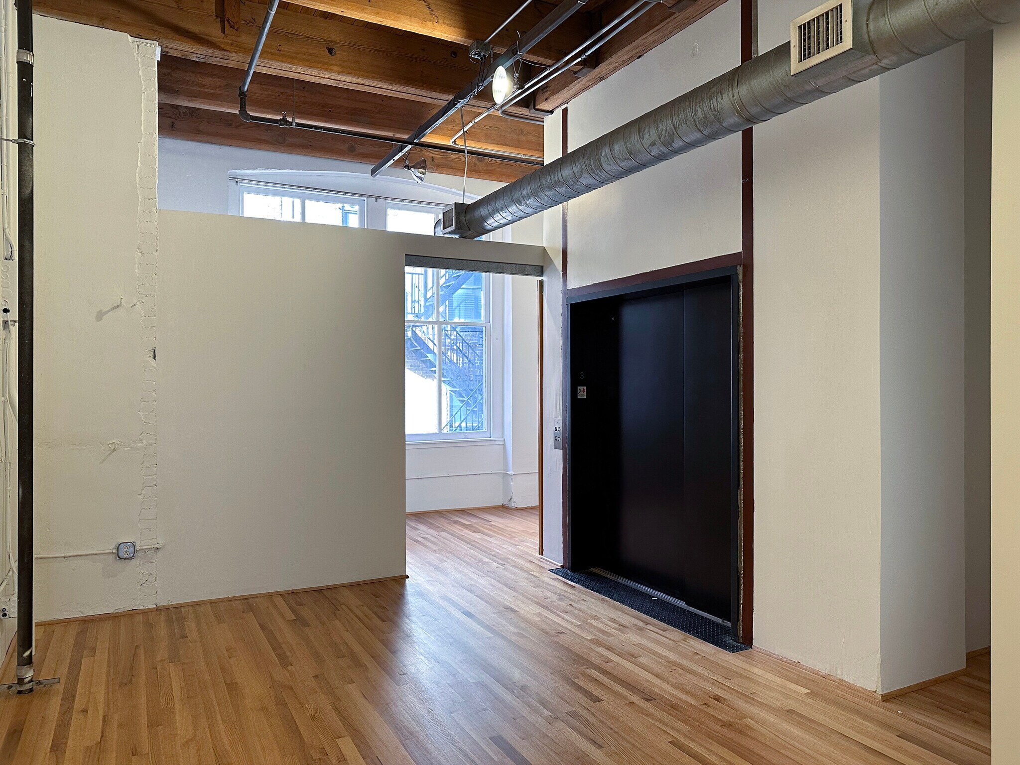 View of elevator + space at rear of the unit with sliding door - 945 Liberty Ave