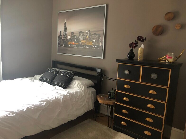 Cozy bedroom with closer w/ built-in shelving and drawer system - 3654 N Janssen Ave