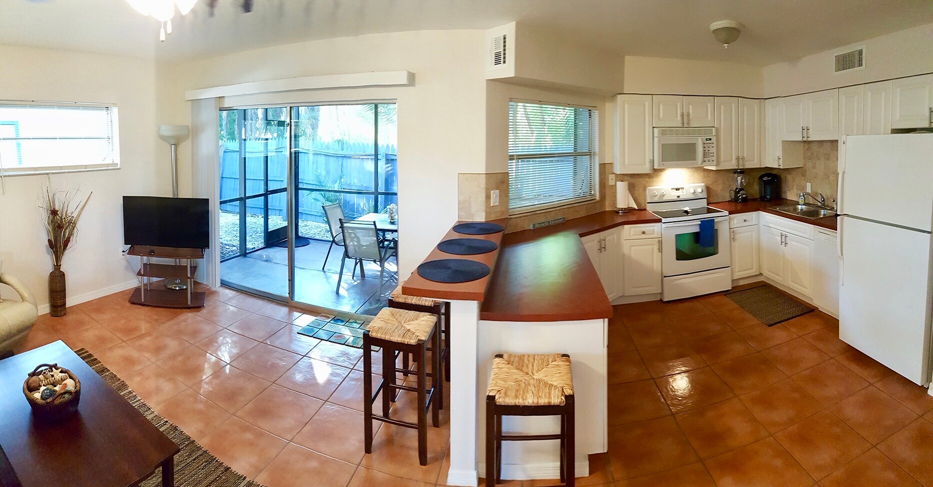 Living/kitchen opens to screened patio. - 7006 Midnight Pass Rd