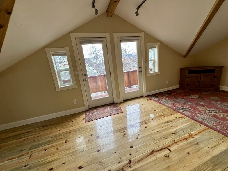 Beautiful natural light with sitting porch among the treetops. - 812 E Cache La Poudre St