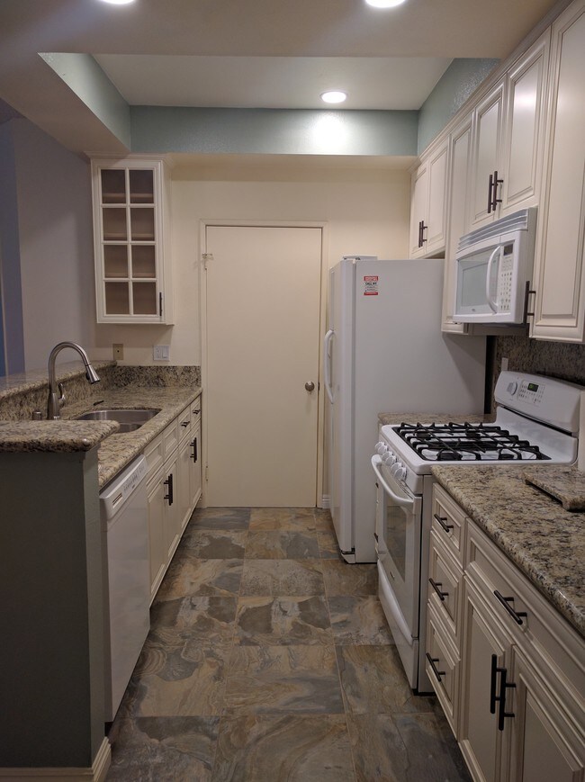 Full kitchen with pantry door - 10021 Tabor St