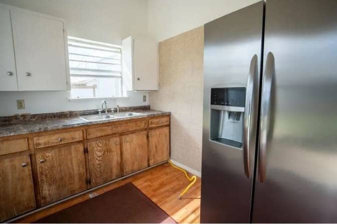 Kitchen space with front door behind - 305 Branch St