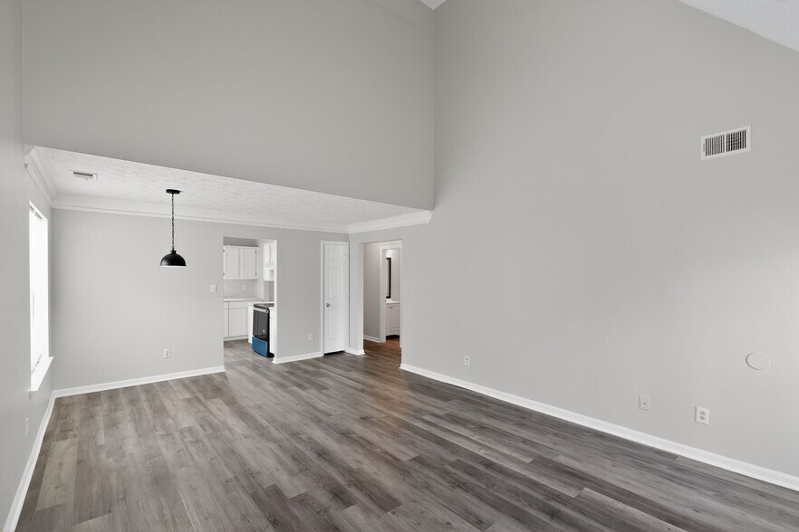 Living room, dining area, and access to kitchen - 1029 Plantation Way NW