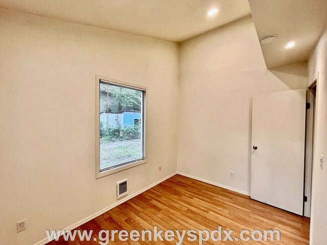 Building Photo - This 3-bedroom 1-bathroom house has a large front yard and a mostly fenced backyard.