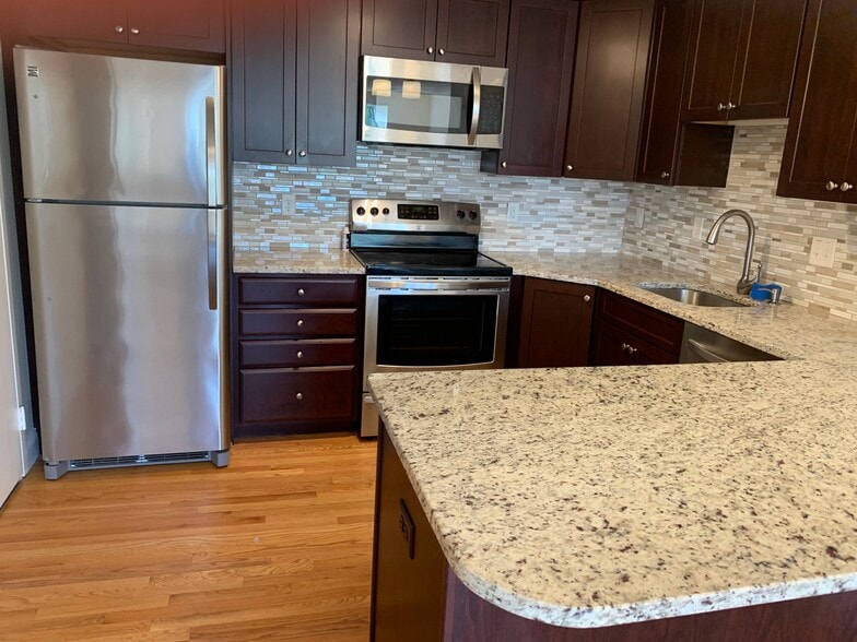 Kitchen with SS Fridge, Range, Microwave, Dishwasher, Disposal - 1105 Lexington St