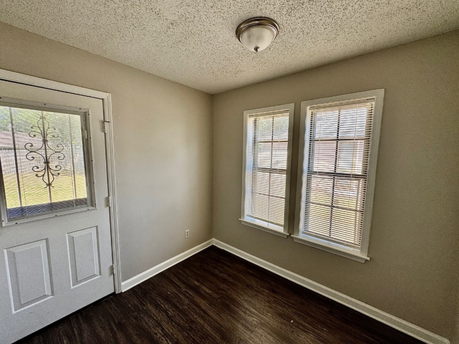 Building Photo - Charming 3BR/2BA Near Southwind | Soaring Vaulted Ceilings, Brick Fireplace & Fenced Yard