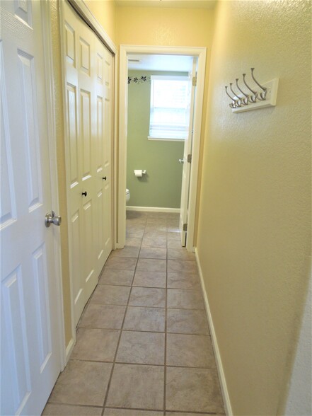 Hallway to main floor powder room - 16441 Martingale Dr