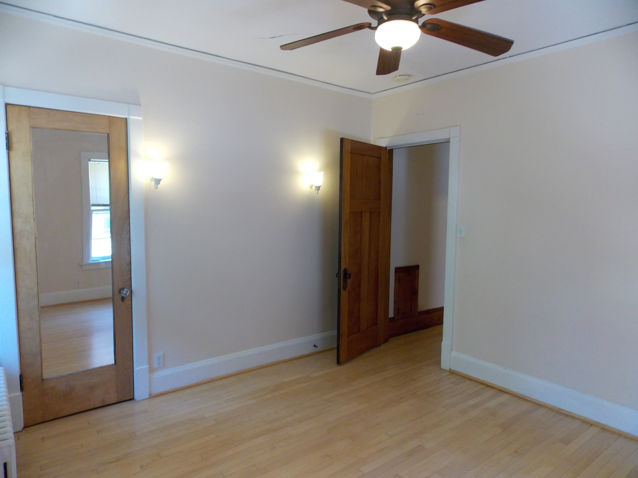 bedroom with wall sconces - 3408 N Downer Ave
