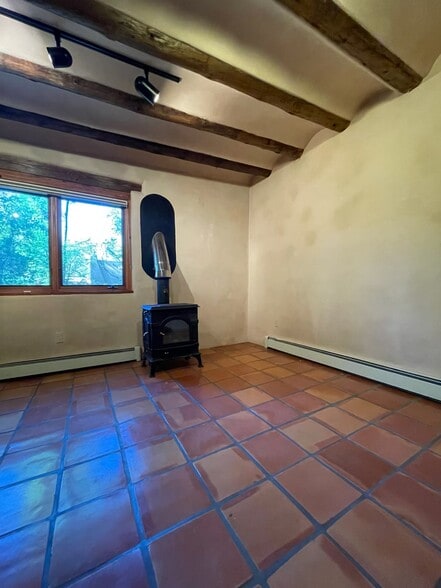 Dining area with stove and baseboard heat - 1470B Bishops Lodge Rd