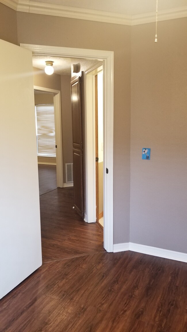 Looking from 3rd bedroom towards master. Bath/storage on the right, 2nd bedroom to the left - 10809 E 100th St N