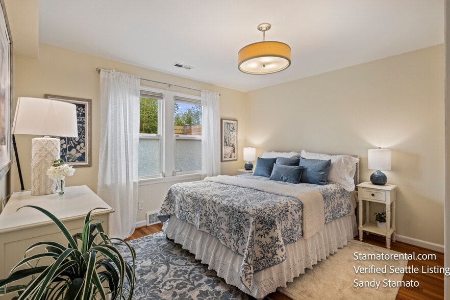 Comfortable second bedroom with garden views and natural light. - 11639 1st Ave NW