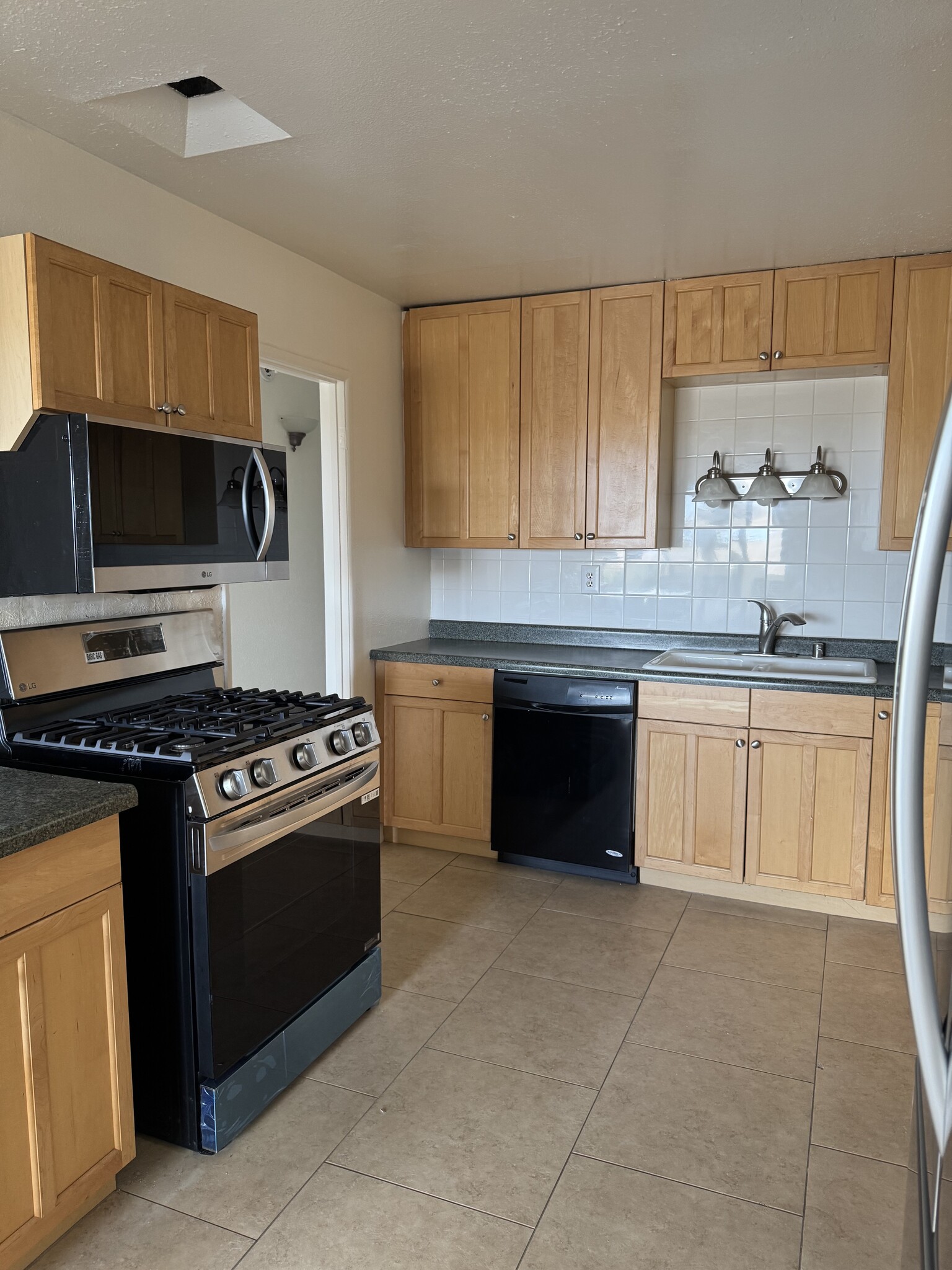 kitchen w/ new stove and microwave - 7015 Trolleyway