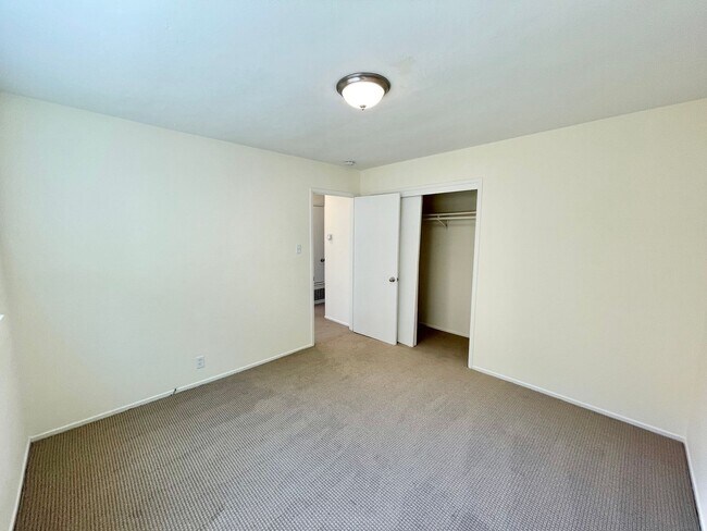 Building Photo - Sunlit 2BD/1BA w/ Private Balcony + Backyard! New Carpet! Assigned Parking! PROGRESSIVE