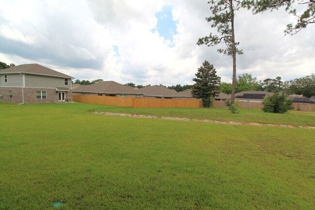 Building Photo - Coming Available Soon – 4BR/2BA Brick Home with Open Floor Plan, Solar Panels & 2-Car Garage in L...