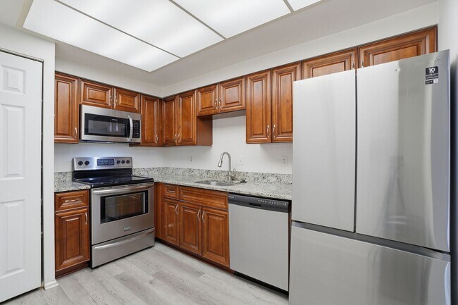 Building Photo - This expansive ground level residence is set within a serene, gated garden community surrounded b...