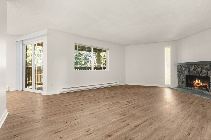 Experience warmth and style in this expansive living room, perfect for family gatherings. - Ridgedale Apartments