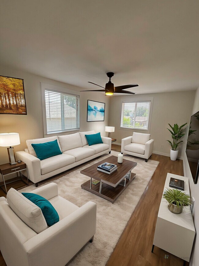 Elegant living room with modern white sofas, vibrant teal cushions, and stylish wooden decor, perfect for a cozy home ambiance. - 212-218 Longs Peak