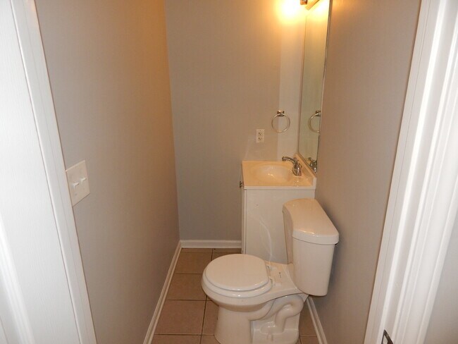Building Photo - Freshly painted and new flooring in this 4 Bedroom 2 and Half Bath home. Covered front porch with...