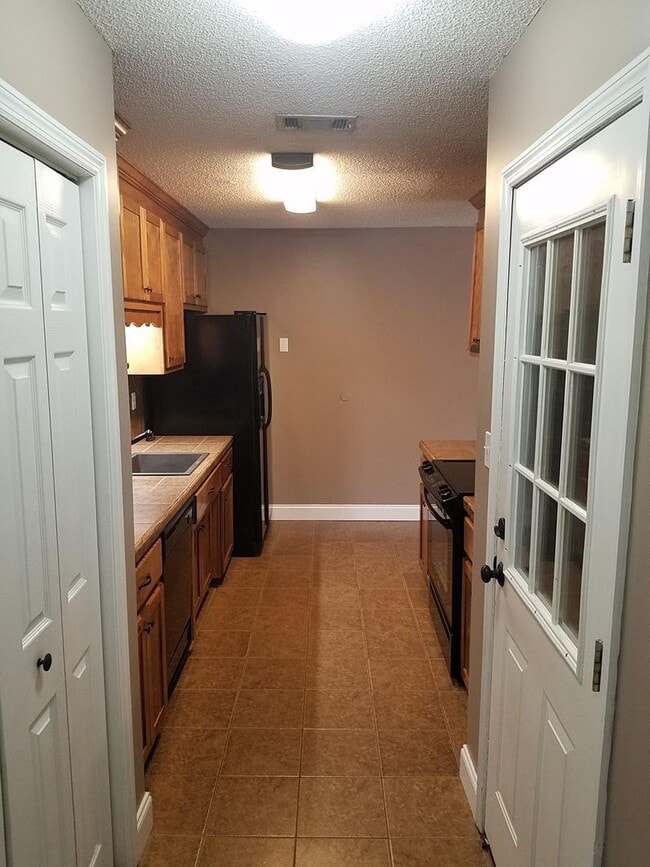 Building Photo - Spacious 3BR Brick Home with Open Split Floor Plan & Tiled Back Porch on Nearly an Acre