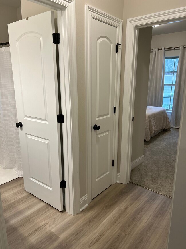 Hallway with 2 bedrooms, a bathroom, and linen closet - 7157 Kenilworth Crossing Ave