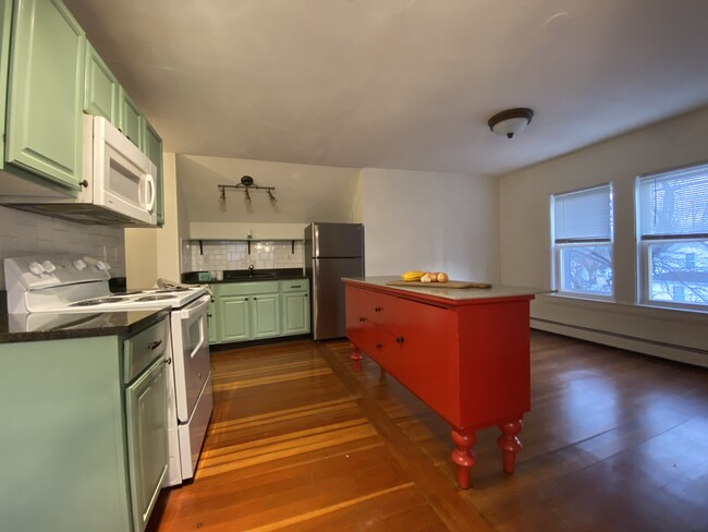 Open kitchen living area with quartz topped vintage island. - 16 Eames St