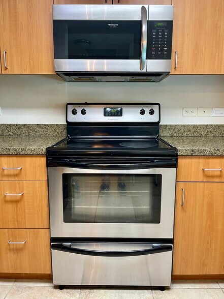 Kitchen - Stainless Frigidaire Convection Microwave and Oven Range - 1080 Park Blvd