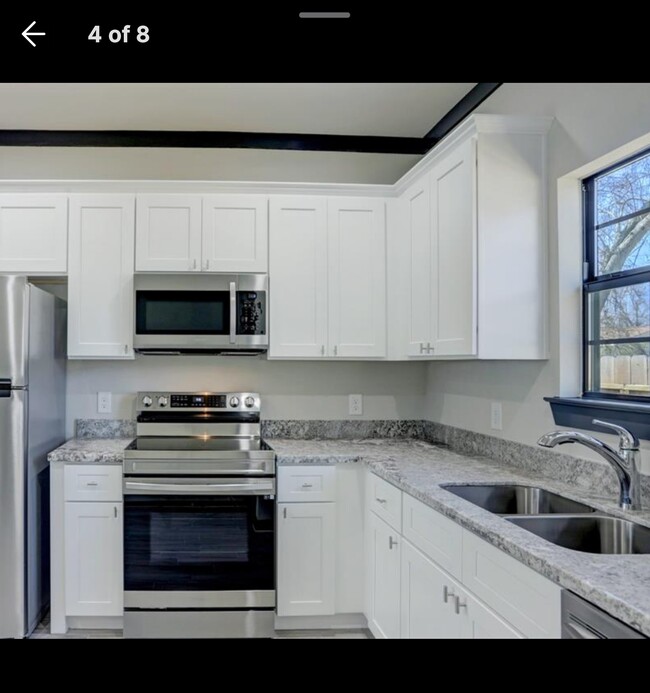 Kitchen with Stainless steel appliances with built in microwave. - 4802 Cruse Rd