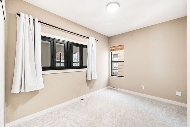 Building Photo - Modern 2BD, 1.5BA Condo with 20' Ceilings and Garage Parking Spot
