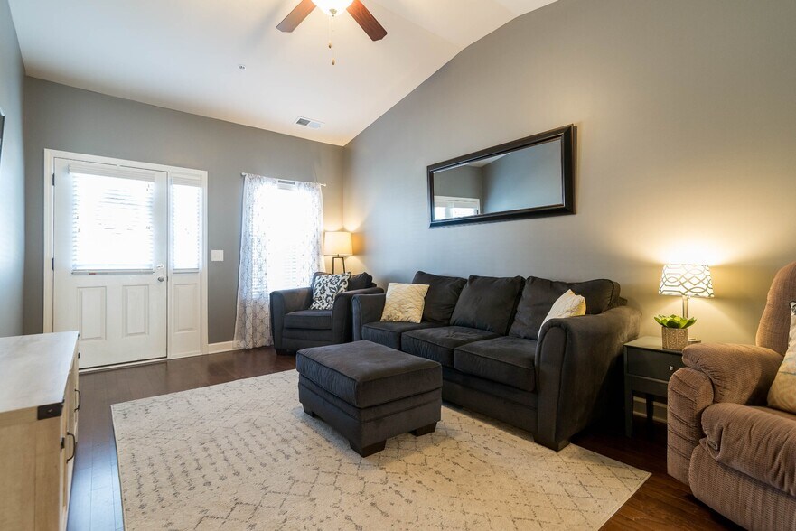 Living room with ceiling fan and vaulted ceiling. - 1040 Charlie Daniels Pkwy