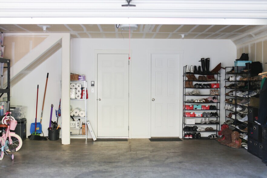 Garage with entrance to main living area (left door) and entrance to versatile room (right door) - 15458 SW Mallard Dr