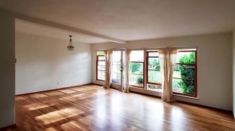 Living / dining room with floor-to-ceiling wood windows that open to private courtyard - 6821 NE Broadway