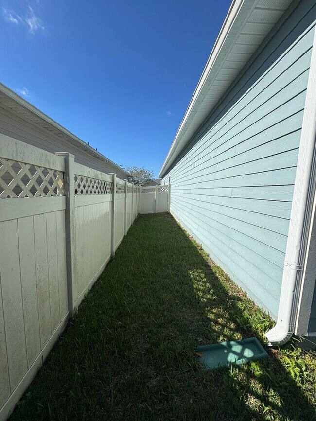 Building Photo - COMING SOON! Beautiful 4BR 3BA Home w/ Screened Lanai & Pond View • Garage Parking • Fenced Yard ...