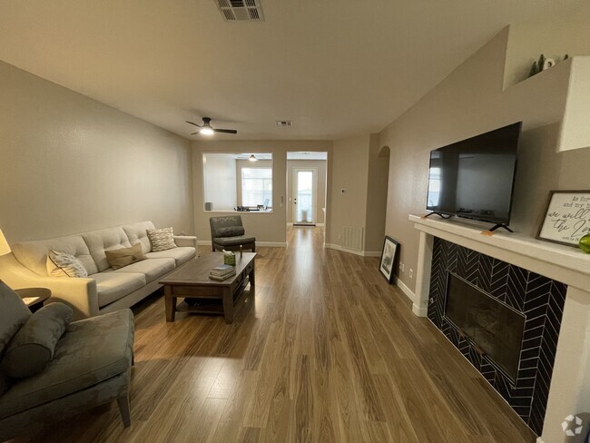 Living room w/ gas fireplace. - 12484 Heatherton Ct