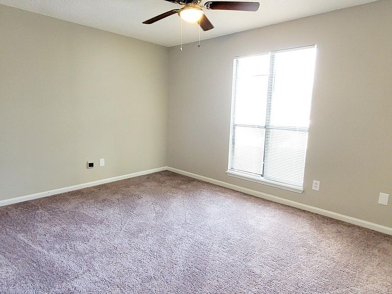 Bright 2nd Bedroom with new paint, flooring, ceiling fan, and closet. - 1300 Bay Hill Blvd.