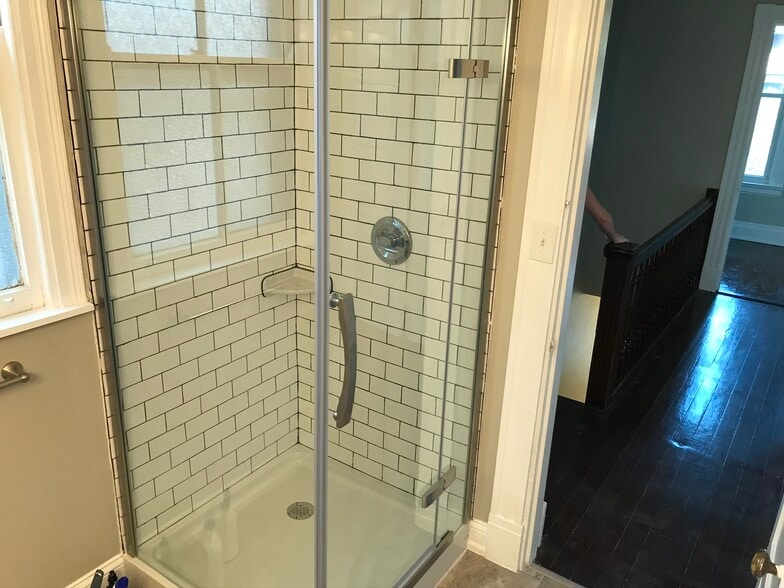 Tile shower with glass enclosure. - 2221 Oakland Ave