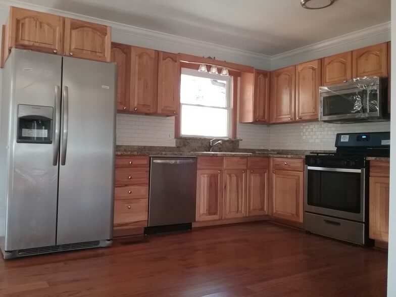 Granite counter-top and sleek tile backsplash - 701 Rosalyn Dr