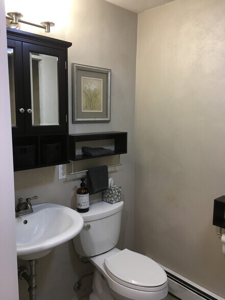 Full bath and laundry room on first floor. 24x24 Porcelain tiles and In floor. - 924 Byford Boulevard