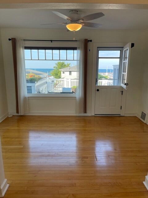 Living Room w/ amazing lake views, original maple floors & a Dutch door to a private 12'x8' deck. - 2650 S Shore Dr