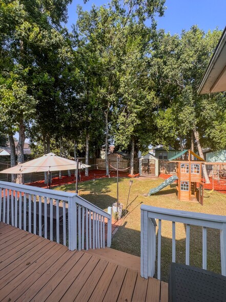 Massive landscaped backyard with playground, trees, patio, deck - 5717 Pasteur Blvd