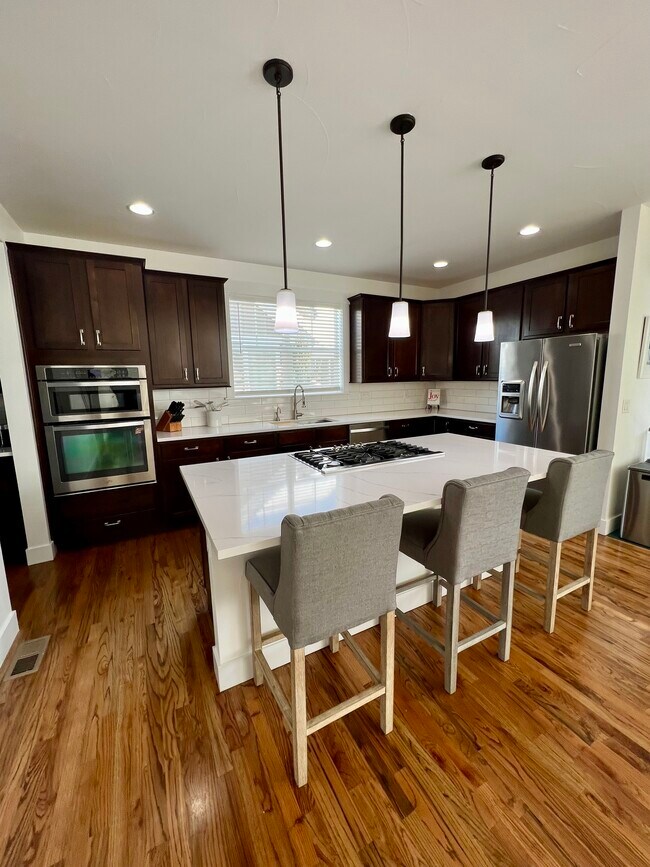 Gas cooktop in the island with downdraft vent. - 2822 Cascade Creek Dr