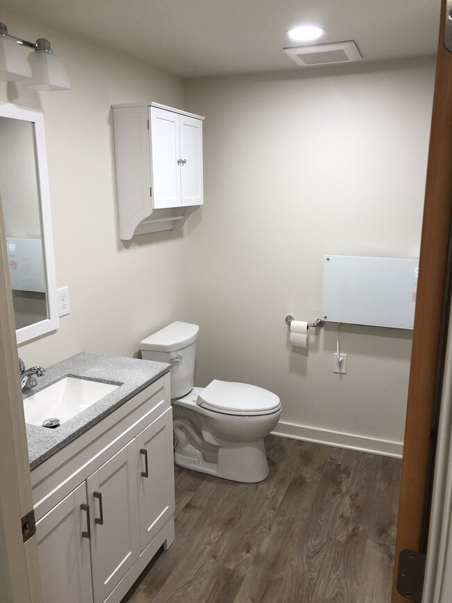 All-new bathroom with plenty of storage and light. - 4842 NE Mallory Ave