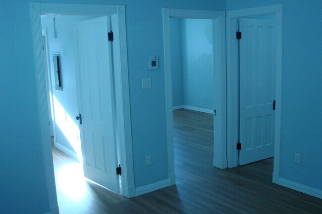 View from dining room into front hallway, living room and front bedroom - 713 Orchard St