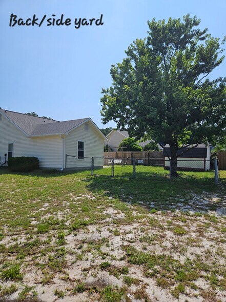 Fenced in backyard with cement patio and storage shed. Side yard has 2 trees. - 2127 Winter Moss Ln