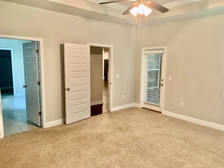 Master bedroom has access to screened in back porch living area - 9040 Lakeview Dr